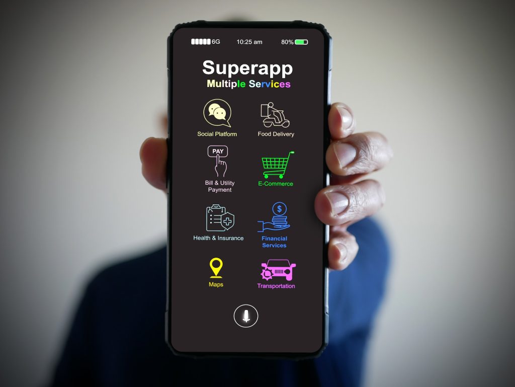 Hand holds a smartphone with a super app for mobile phones that serves multiple services as a o